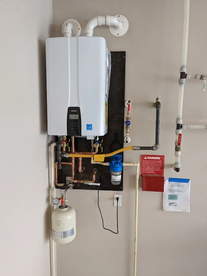 Professional plumber installing copper piping in a West Fargo home